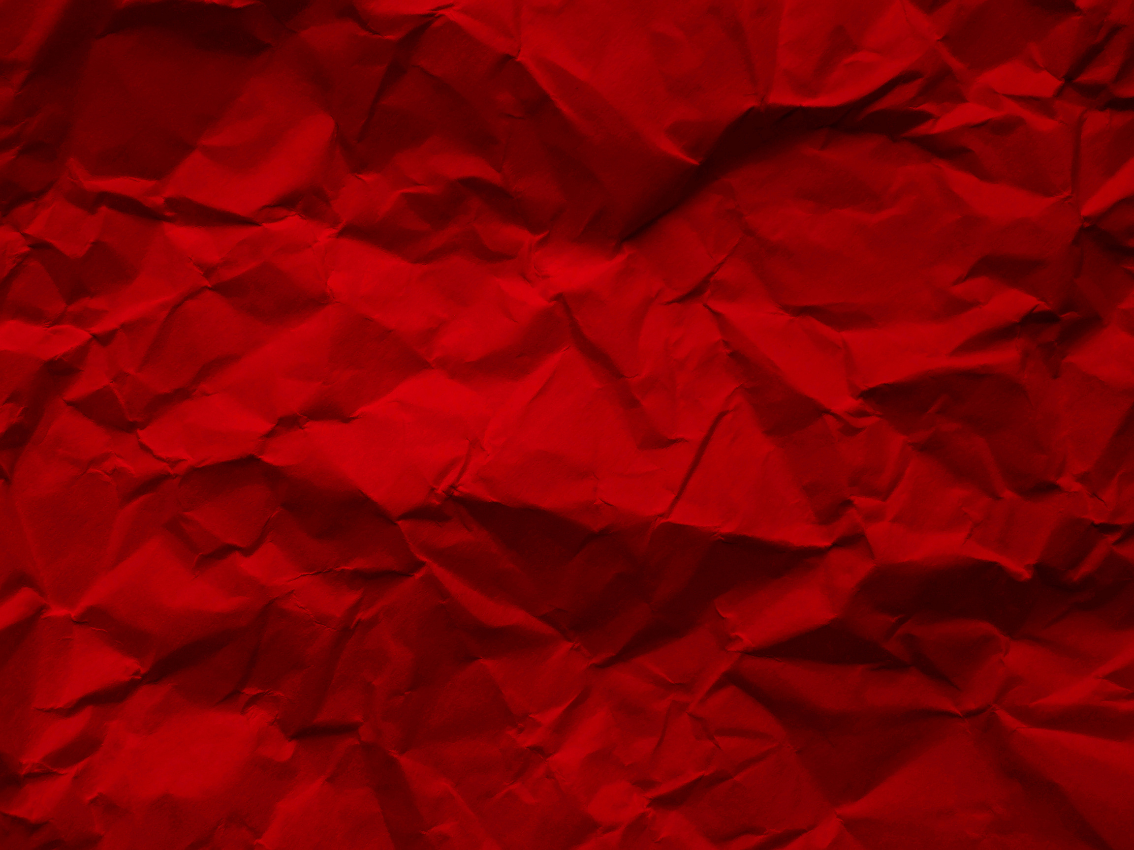 Red crumpled paper texture background